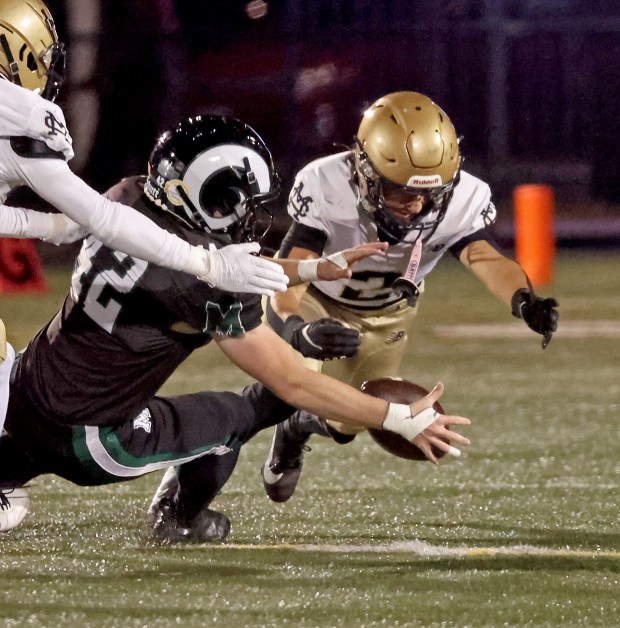 Marshfield's Tim Stiles, left, and Malden Catholic's Anthony Wadland dive on a loose ball. Malden Catholic was a 28-21 winner. (Staff Photo By Stuart Cahill/Boston Herald)