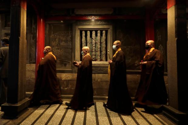 Monks pray on the eve of the Lunar New Year celebrations
