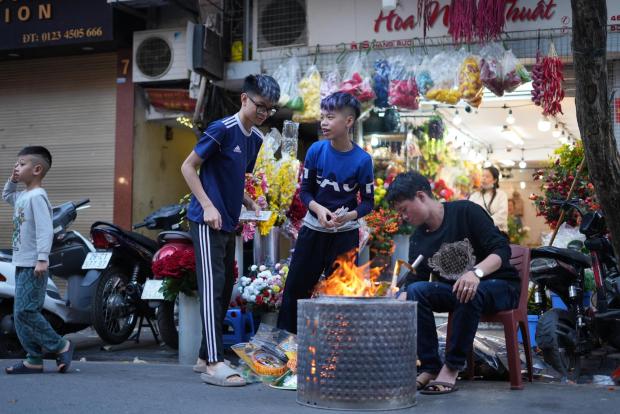 People burn joss paper money as an offering to ancestors ahead of the Lunar New Year