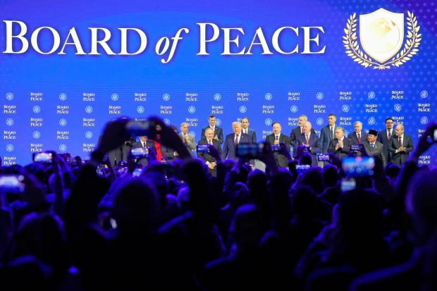 President Trump stands on the podium at the beginning a session on the Board of Peace initiative of US President Donald Trump at the Annual Meeting of the World Economic Forum in Davos