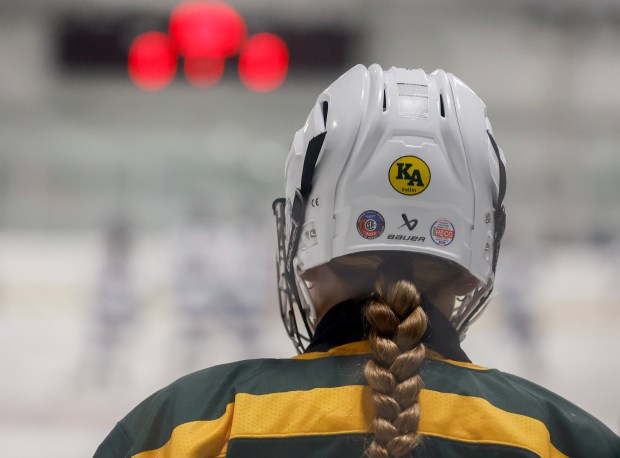 King Philip players honor their late coach Ken Assad by wearing his initials on their helmets against Medfield last Saturday. (Photo by Paul Connors/Media News Group/Boston Herald)
