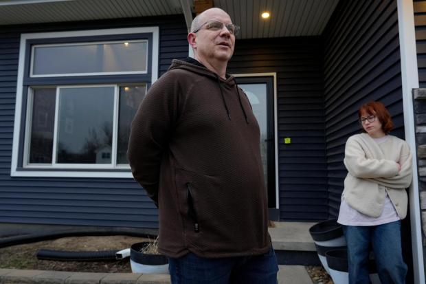 Andrew Coady and his daughter Keira, right, talk about his son, Sgt. Declan Coady, 20, of West Des Moines, Iowa, outside their home, Tuesday, March 3, 2026, in West Des Moines, Iowa. (AP Photo/Charlie Neibergall)