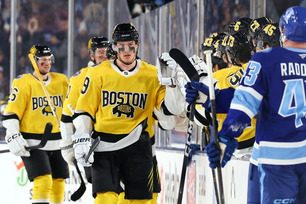 Morgan Geekie of the Boston Bruins is congratulated by his teammates after scoring a goal against the Tampa Bay Lightning during the second period of the 2026 NHL Stadium Series at Raymond James Stadium on February 01, 2026 in Tampa, Florida. (Photo by Mike Carlson/Getty Images)