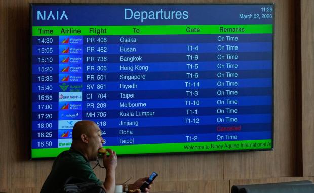 A board shows flight details at the Overseas Filipino Workers lounge at Manila's International Airport.