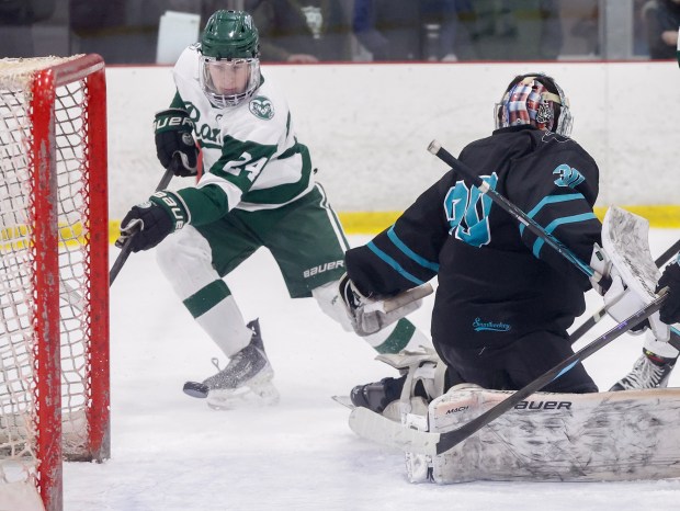 Marshfield's Brendan McLaughlin, left, shoots the puck past Plymouth South goalie Ollie Noyes, right, for a goal during the first period January 17, 2026, in Kingston, Massachusetts. (Photo by Paul Connors/Media News Group/Boston Herald)