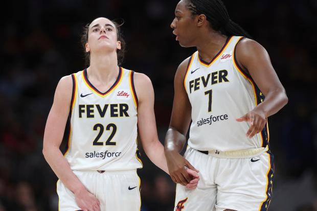 Indiana Fever's Caitlin Clark (22) reacts with a possible injury beside Aliyah Boston (7) during the second half of a WNBA basketball game against the Connecticut Sun, Tuesday, July 15, 2025, in Boston. (AP Photo/Michael Dwyer)
