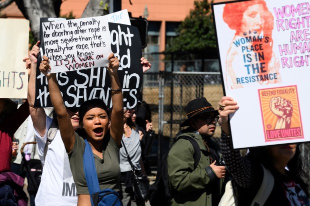 A demonstrator shouts during a march to commemorate International Women's Day Saturday, March 8, 2025, in Los Angeles. (AP Photo/William Liang)