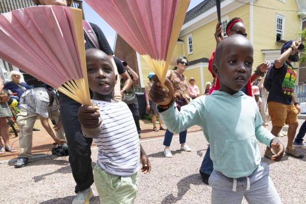 Levis Martin, left, and his brother Daniel dance with fans during a Juneteenth celebration in Portsmouth, N.H.