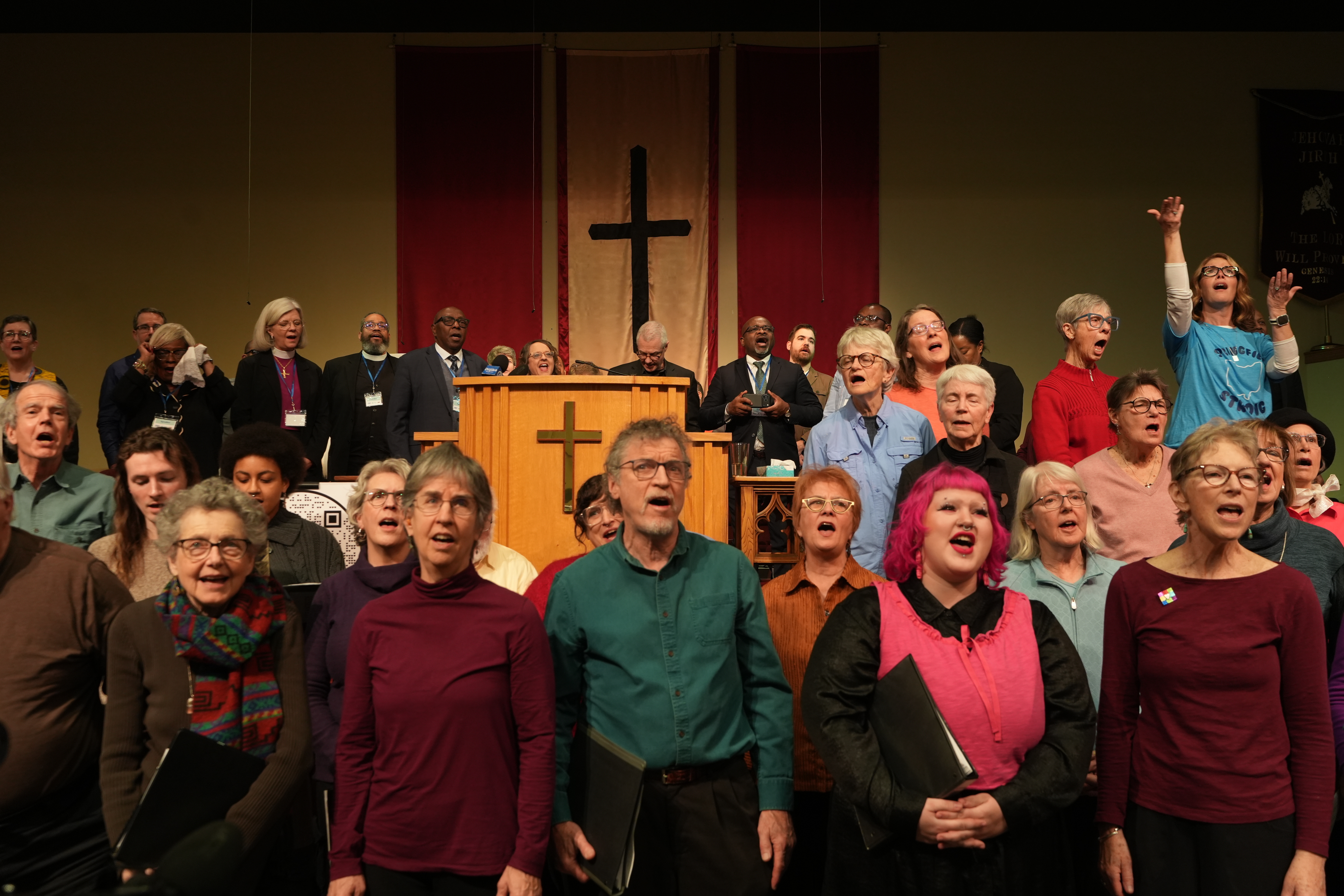 Faith leaders and members of the World House Choir sing...