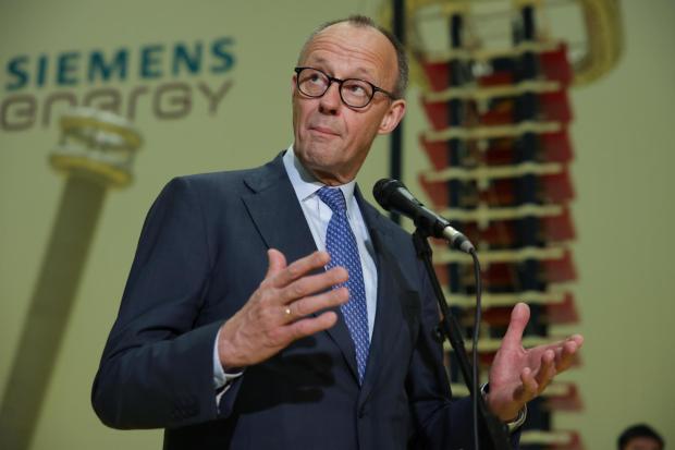 German Chancellor Friedrich Merz speaks before media members as he visits facilities of Siemens Energy during his official visit, in Hangzhou, China, Thursday, Feb. 26, 2026. (Andres Martinez Casares/Pool Photo via AP)