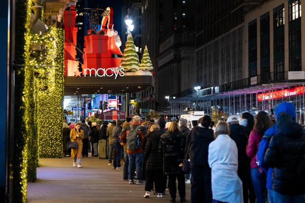 Black Friday Shoppers wait in line to enter Macy's flagship store on Friday, Nov. 28, 2025 in New York. (AP Photo/Angelina Katsanis)