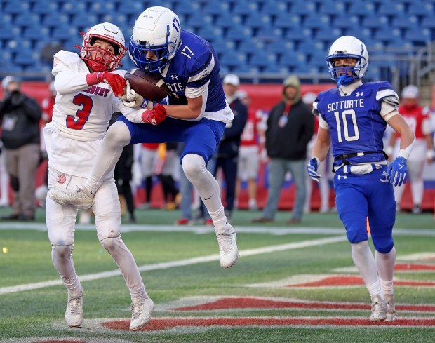 Scituate's Miller Shea catches the game-winning touchdown against Tewksbury's Sean Callahan as Tyler Stelljes looks on during the Div. 4 Super Bowl on Saturday. (Photo By Matt Stone/Boston Herald)