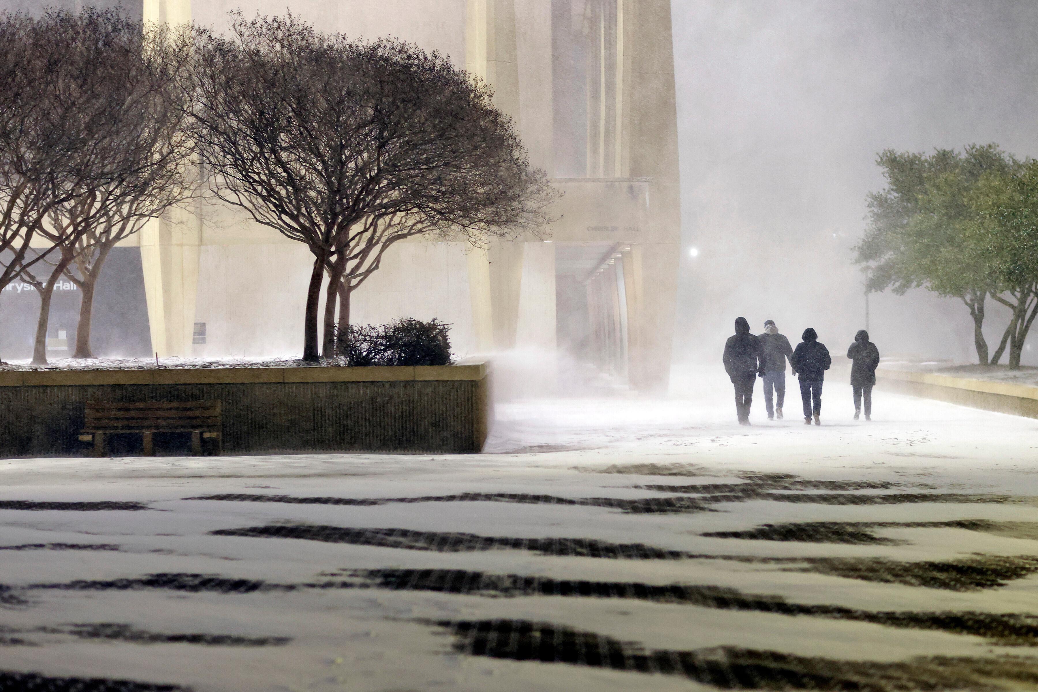 Fans leave in the snow from the ice hockey game...