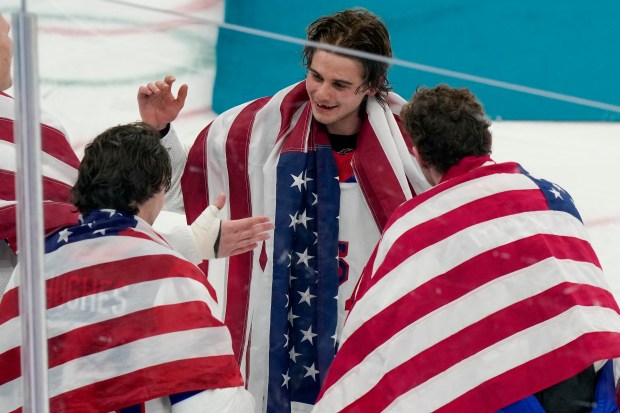 United States' Jack Hughes, center, celebrates with teammates after the United States beat Canada in the men's ice hockey gold medal game at the 2026 Winter Olympics, in Milan, Italy, Sunday, Feb. 22, 2026. (AP Photo/Luca Bruno)
