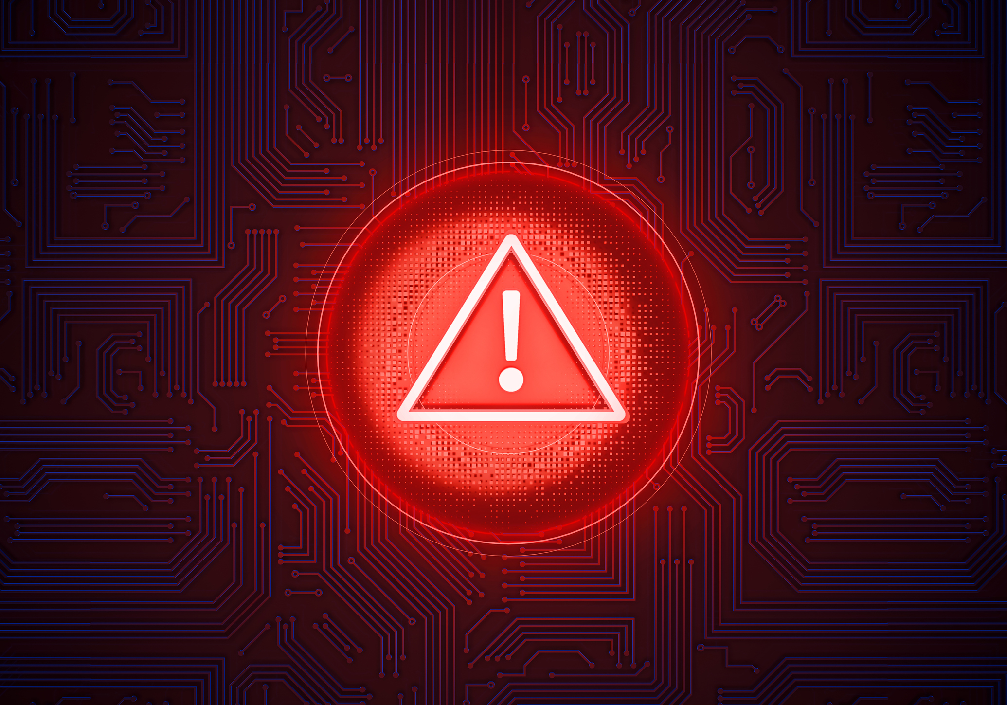Warning Sign of digital risk: A luminous red warning sign in the shape of a circle with an exclamation mark centered, stands out against a dark tech background