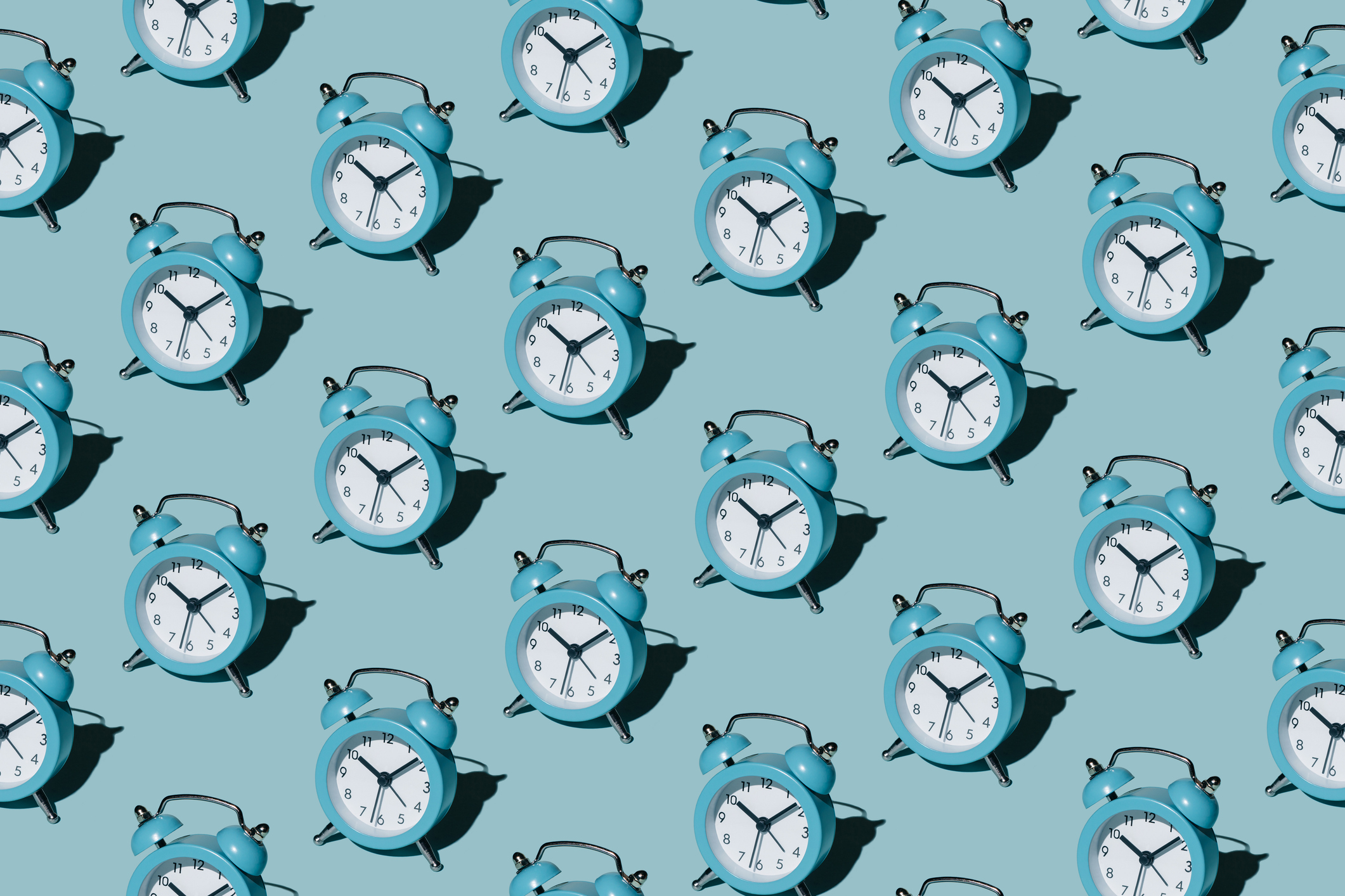 Pattern of alarm clocks on a blue background