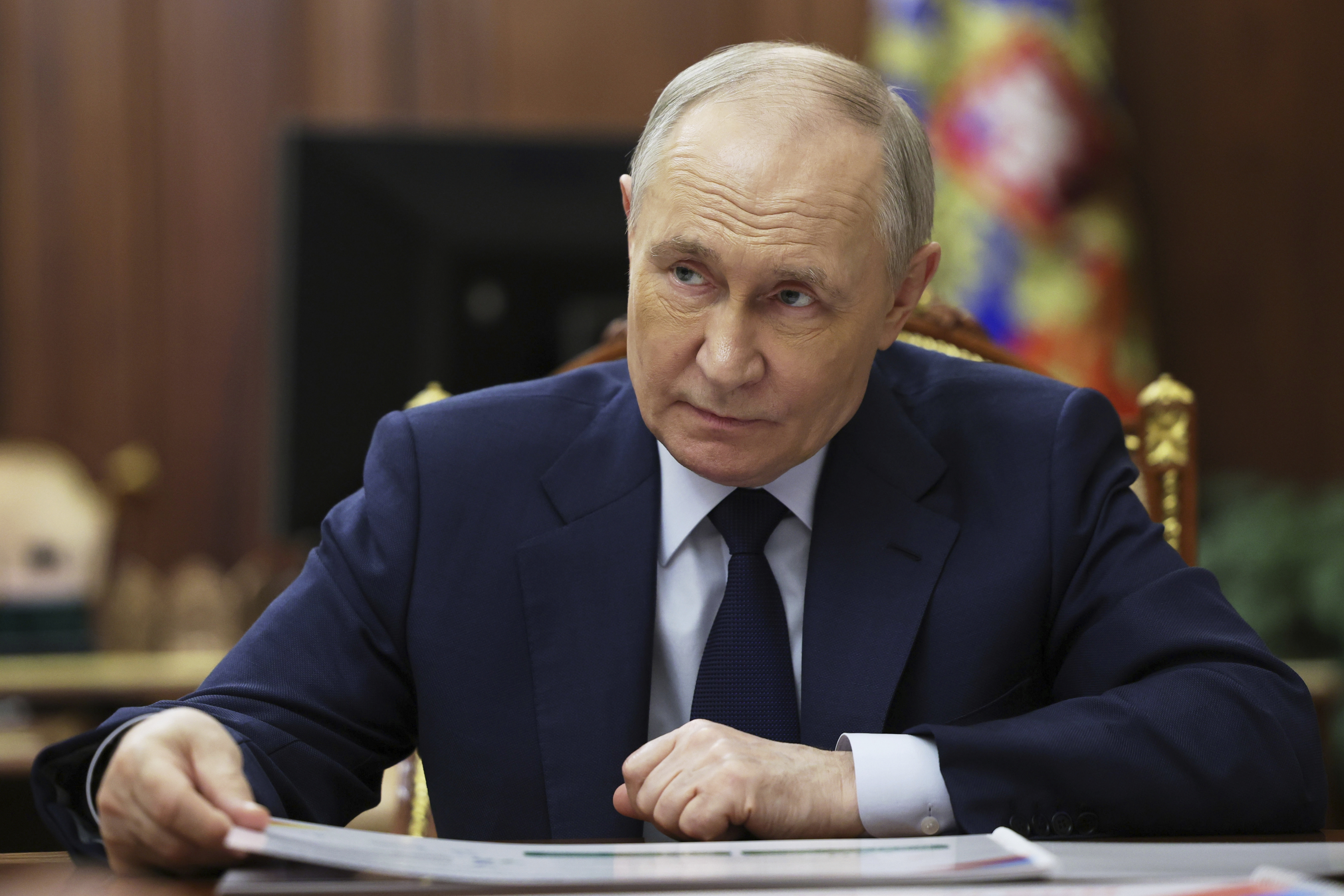 Vladimir Putin listening at the Kremlin.