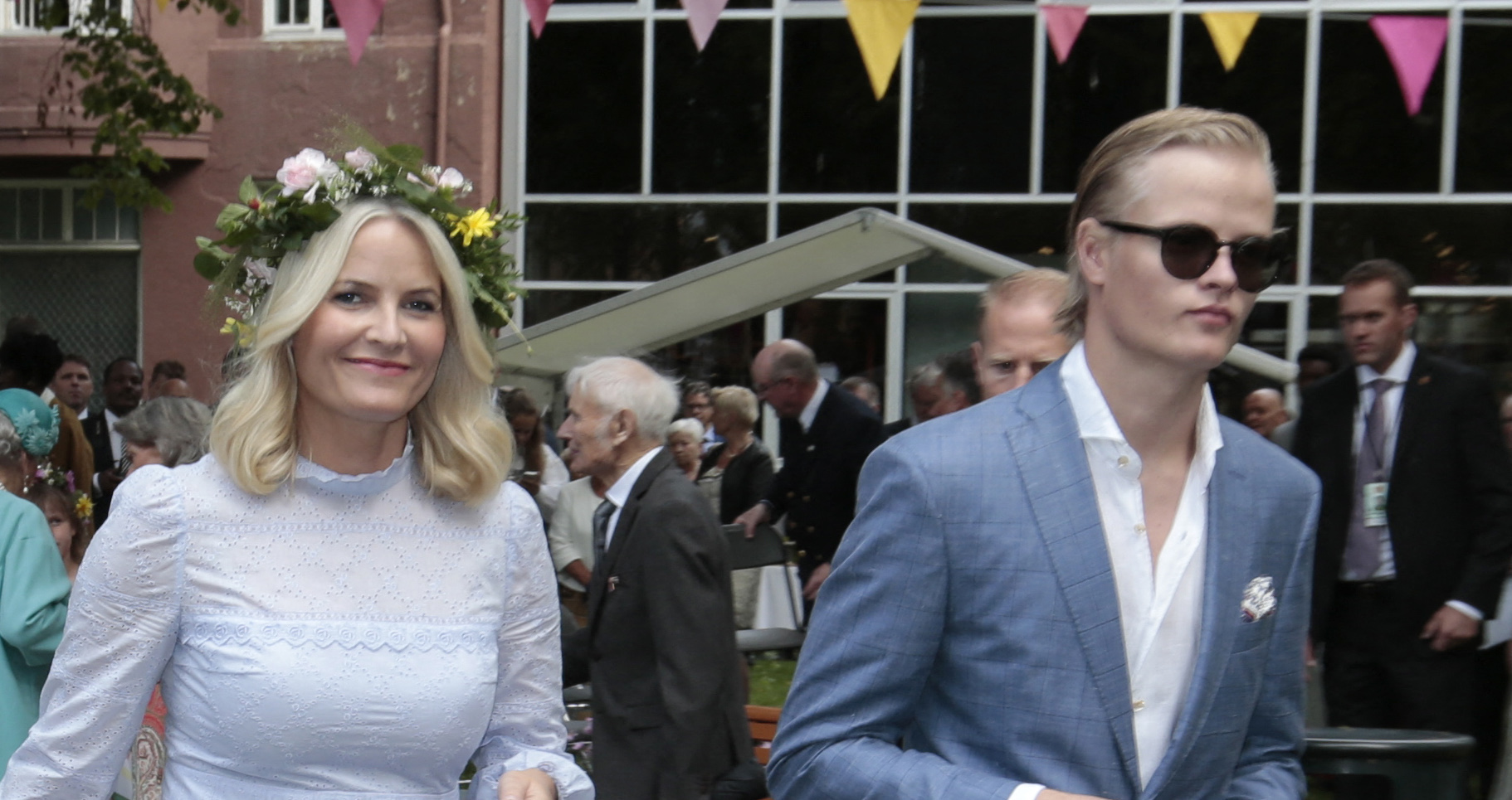 Mette-Marit, Crown Princess of Norway, and her son Marius Borg Høiby at a garden party.