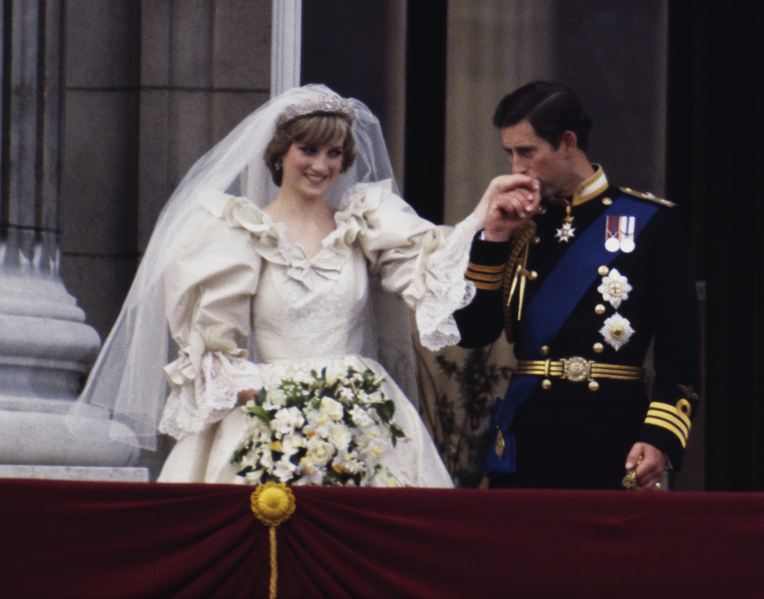 The Prince and Princess of Wales on the balcony of Buckingham Palace on their wedding day, 29th July 1981. Diana wears a wedding dress by David and Elizabeth Emmanuel and the Spencer family tiara. (Photo by Terry Fincher/Princess Diana Archive/Getty Images)