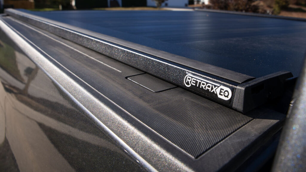 A close-up image of a Retrax EQ Tonneau Cover focusing on the logo.